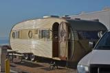19089023-vintage-gold-travel-trailer-camping-at-beach.jpg